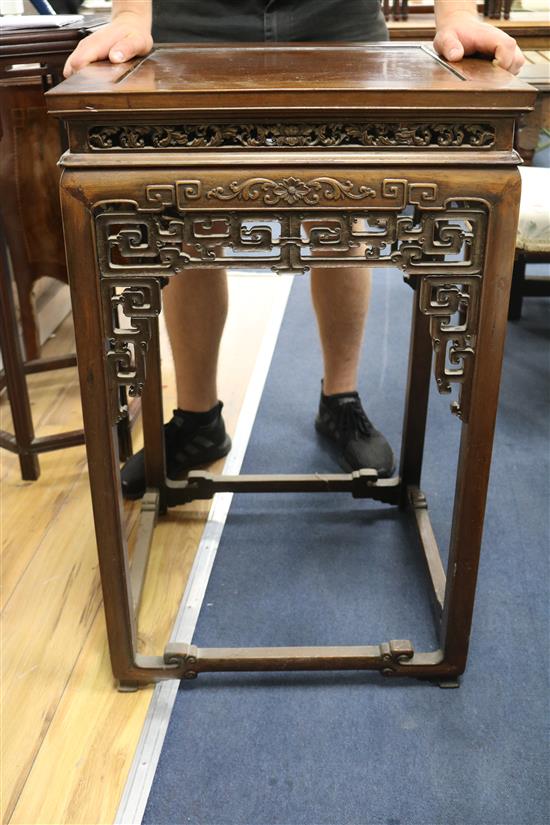 A Chinese huali wood urn stand, having panelled top and pierced frieze W.52cm